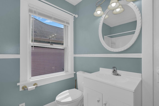 bathroom with a shower, vanity, and toilet