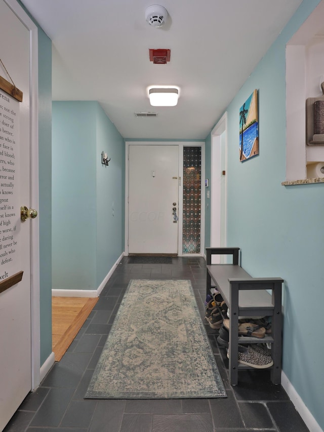 hall with dark tile patterned flooring