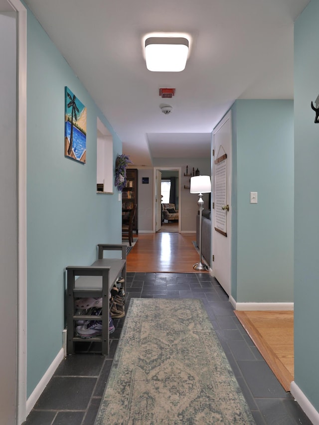 hallway with dark hardwood / wood-style flooring