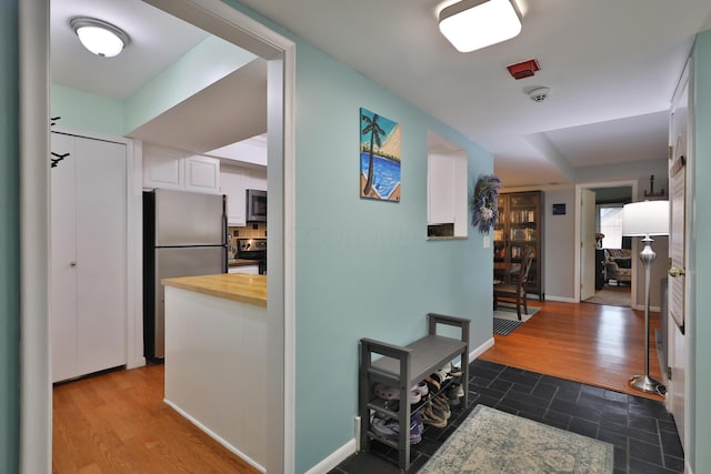 corridor with hardwood / wood-style floors