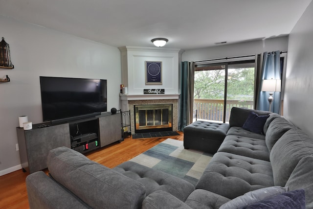 living room featuring hardwood / wood-style floors and a tile fireplace