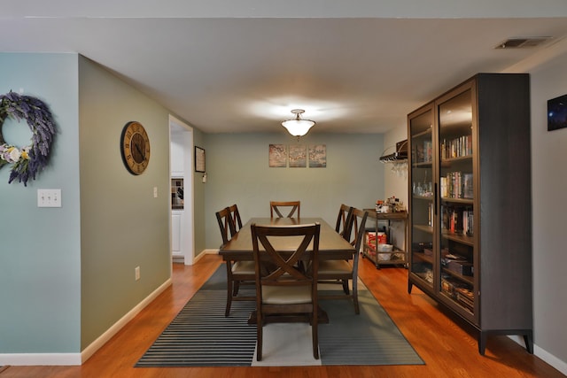 dining space with hardwood / wood-style floors