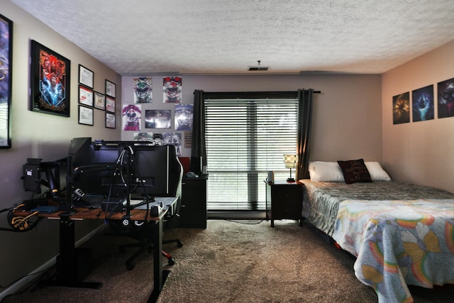 bedroom with carpet floors and a textured ceiling