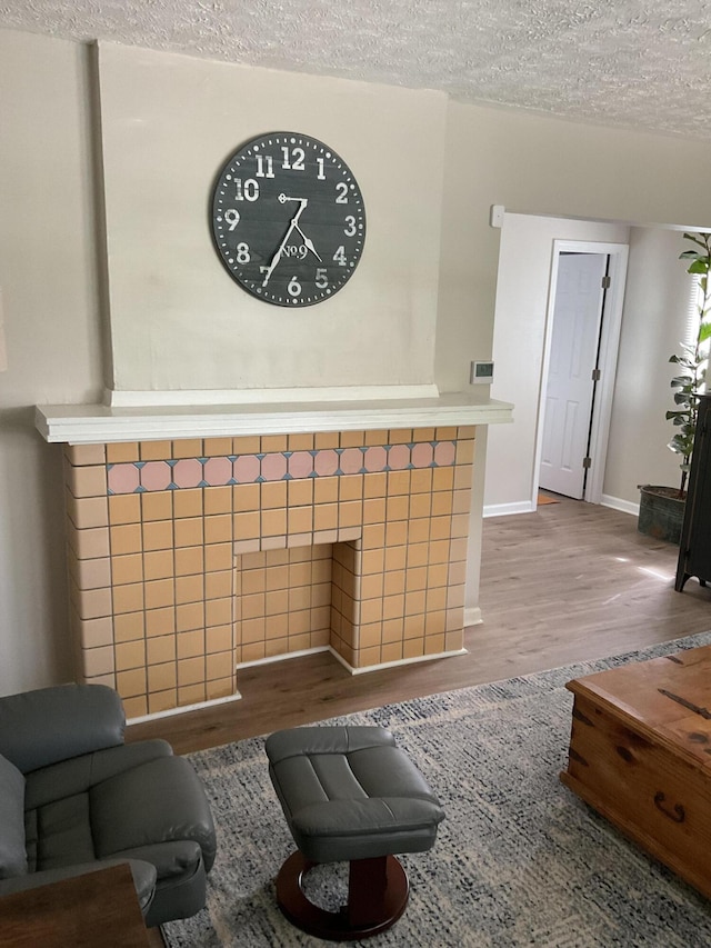 living room featuring hardwood / wood-style floors and a textured ceiling