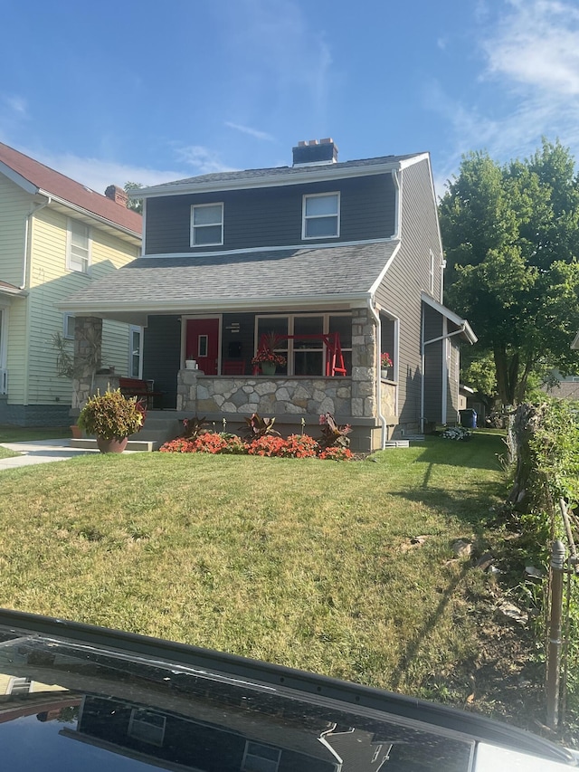 front facade with a porch and a front yard