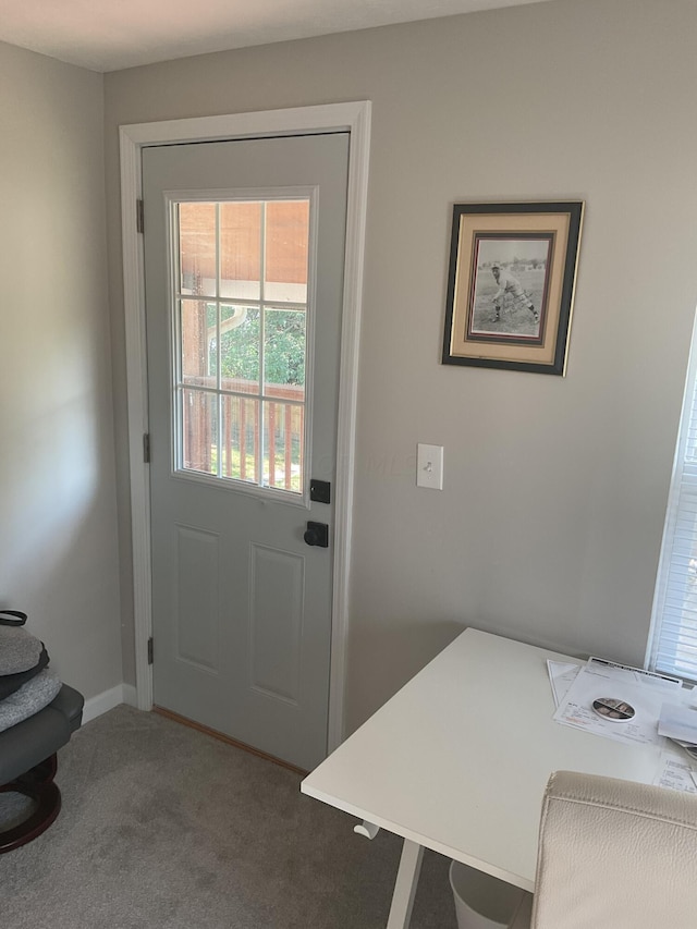 doorway to outside featuring carpet flooring