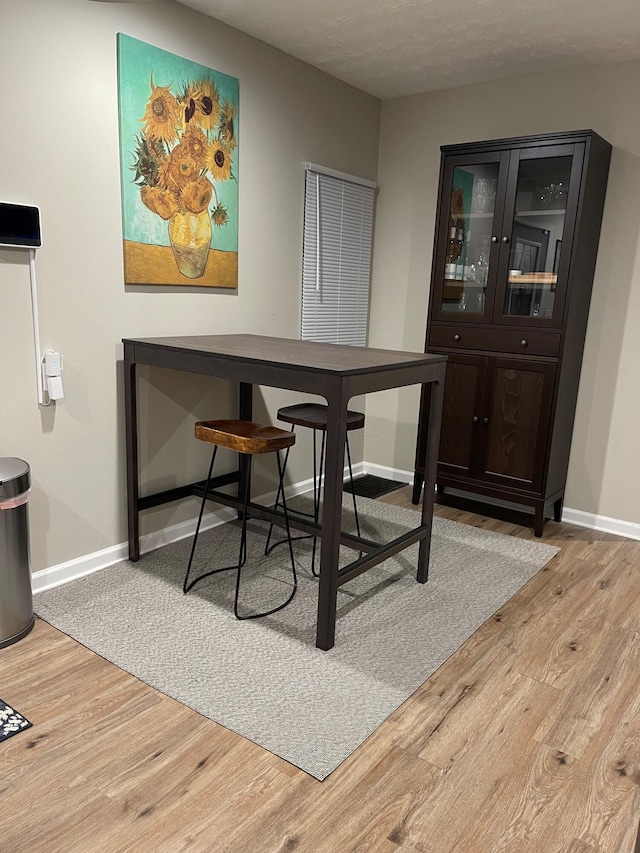 dining space with light hardwood / wood-style flooring