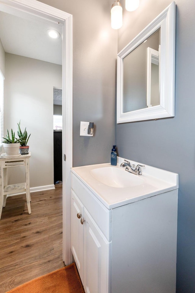 bathroom with vanity and hardwood / wood-style flooring