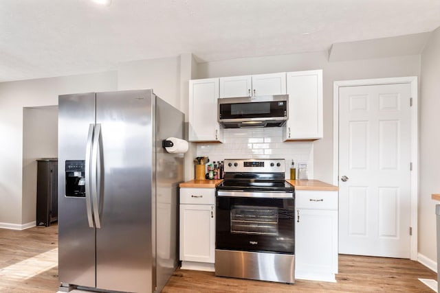 kitchen featuring white cabinetry, light hardwood / wood-style floors, wooden counters, and appliances with stainless steel finishes