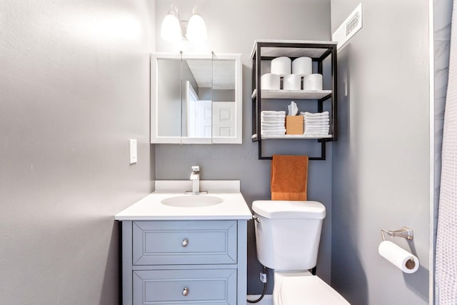 bathroom featuring vanity and toilet