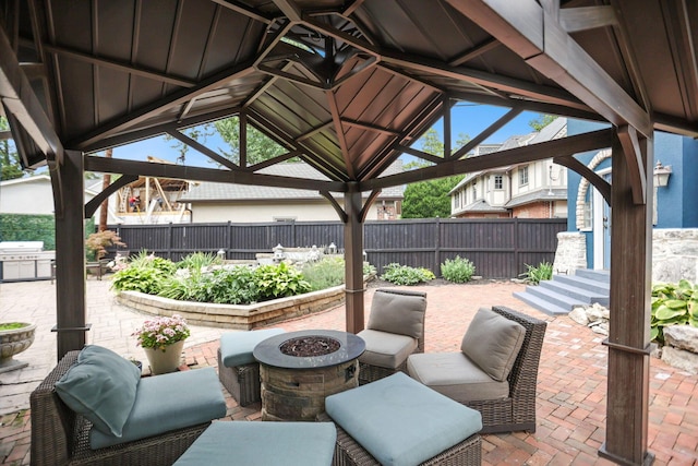 view of patio / terrace with a gazebo, a grill, and a fire pit