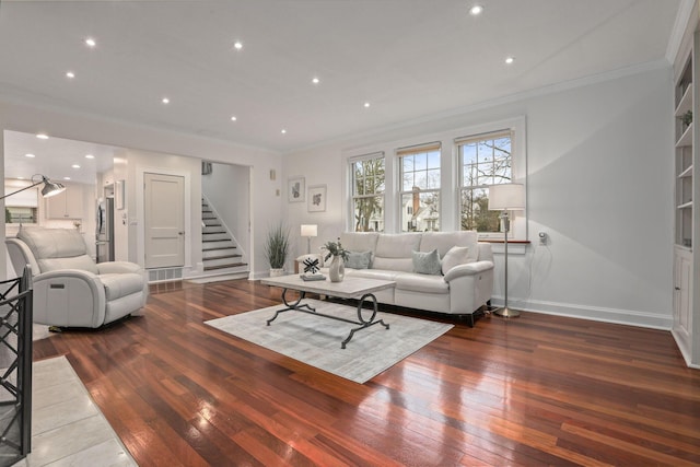 living room with hardwood / wood-style floors and crown molding