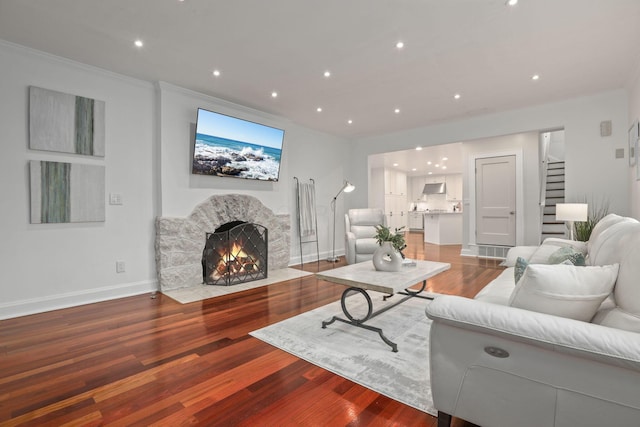 living room with hardwood / wood-style flooring and ornamental molding