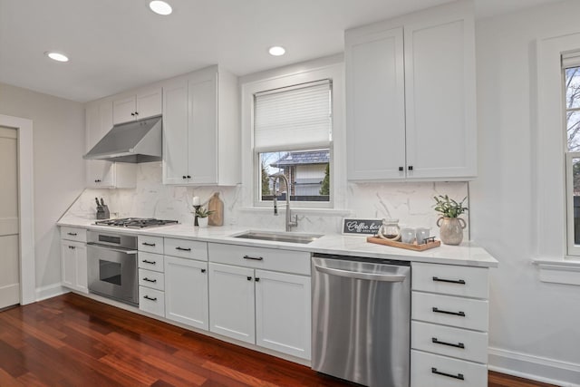 kitchen with sink, a wealth of natural light, stainless steel appliances, and white cabinets