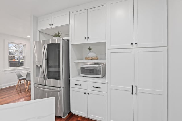 kitchen featuring white cabinetry, dark hardwood / wood-style flooring, and appliances with stainless steel finishes