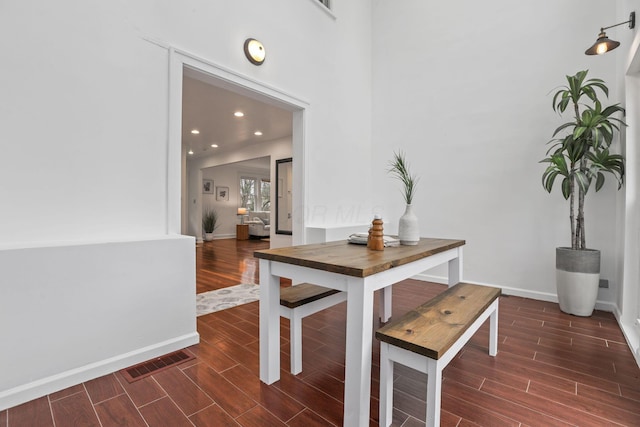 dining area with a towering ceiling