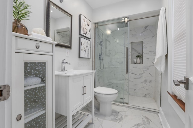 bathroom with vanity, an enclosed shower, and toilet