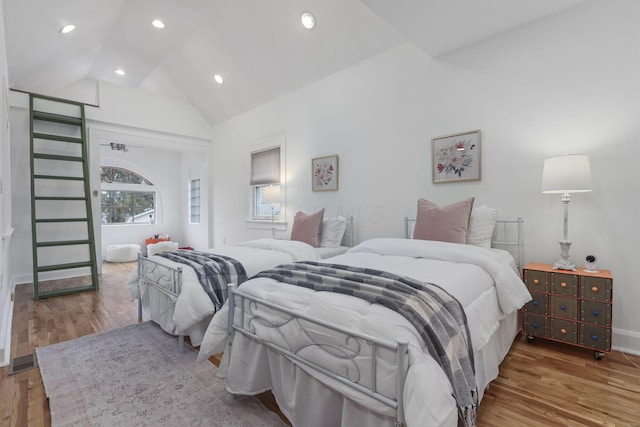 bedroom featuring lofted ceiling and hardwood / wood-style floors