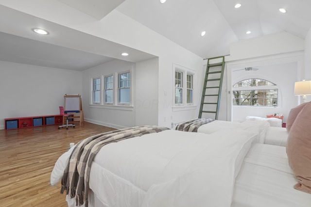 bedroom with hardwood / wood-style flooring and lofted ceiling