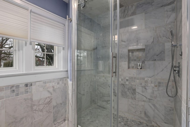 bathroom with a shower with door