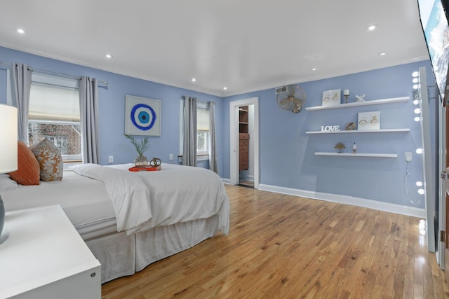 bedroom with ornamental molding and light wood-type flooring