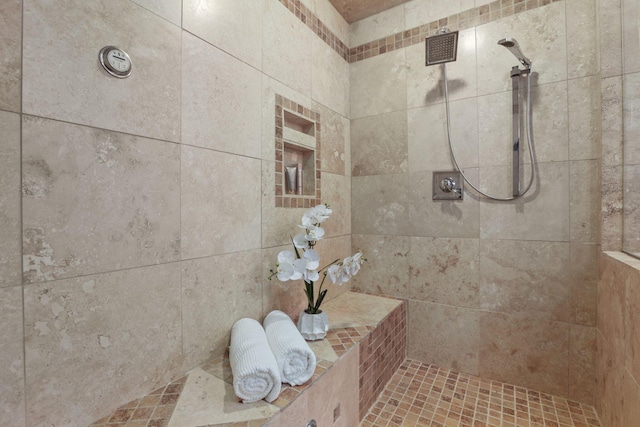 bathroom with tiled shower