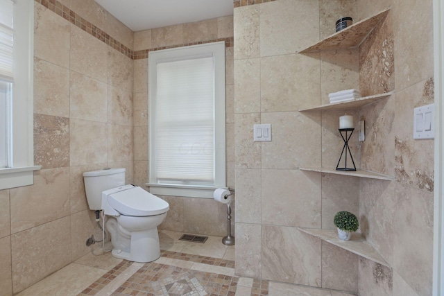 bathroom with toilet and tile walls