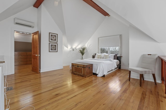 bedroom with beamed ceiling, high vaulted ceiling, a wall unit AC, and light wood-type flooring