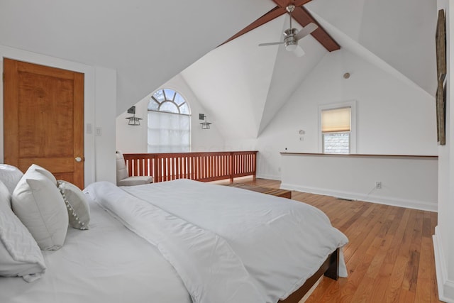 bedroom featuring ceiling fan, lofted ceiling with beams, and light wood-type flooring