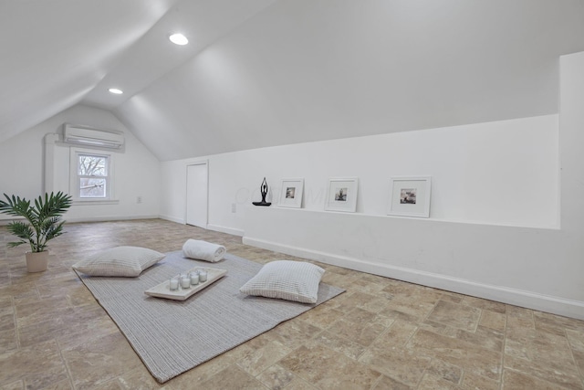 interior space with lofted ceiling and a wall mounted AC