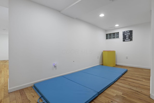 workout room featuring hardwood / wood-style floors