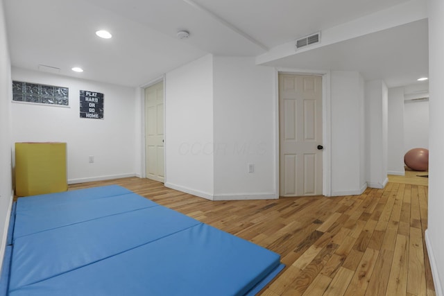 exercise room featuring hardwood / wood-style floors