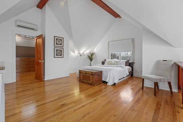 bedroom with beamed ceiling, high vaulted ceiling, a wall unit AC, and light hardwood / wood-style flooring