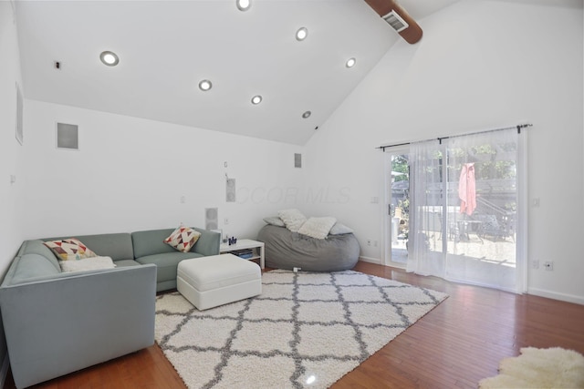 living room with high vaulted ceiling and hardwood / wood-style floors