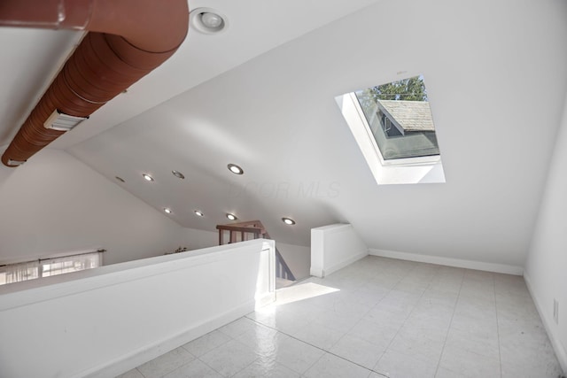 bonus room with lofted ceiling with skylight