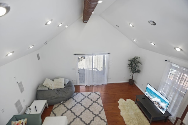 unfurnished living room with dark wood-type flooring and high vaulted ceiling