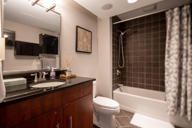 full bathroom featuring tile patterned floors, vanity, toilet, and shower / tub combo