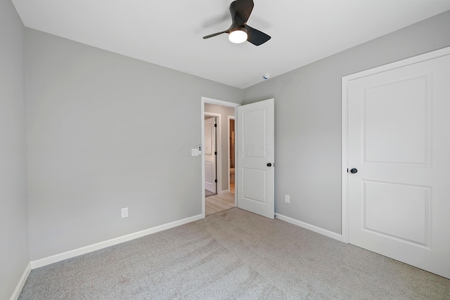 unfurnished bedroom featuring ceiling fan and light carpet