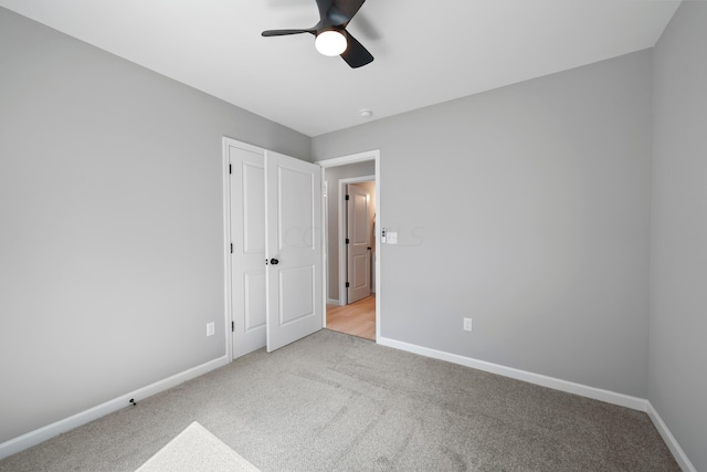 unfurnished bedroom featuring ceiling fan and light carpet