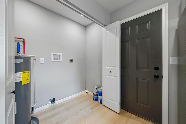 washroom with electric dryer hookup, light wood-type flooring, hookup for a washing machine, and water heater