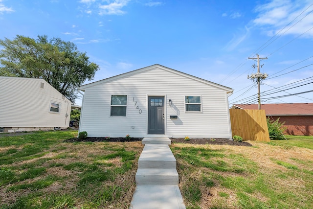 bungalow-style home with a front yard