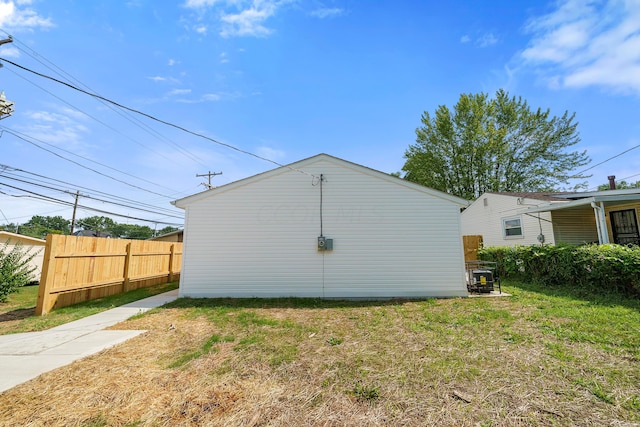 rear view of house featuring a yard