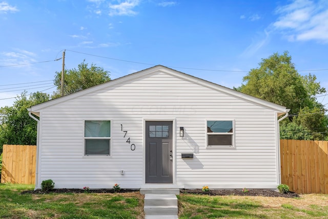 bungalow-style home featuring a front yard