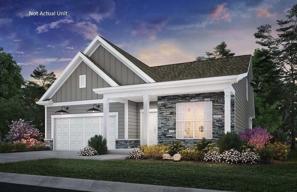 view of front of property with a garage and a lawn