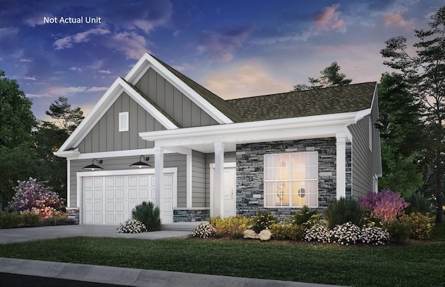 view of front of property with a garage and a lawn