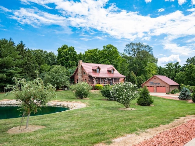 view of front of property with a water view, a garage, a front lawn, and an outdoor structure