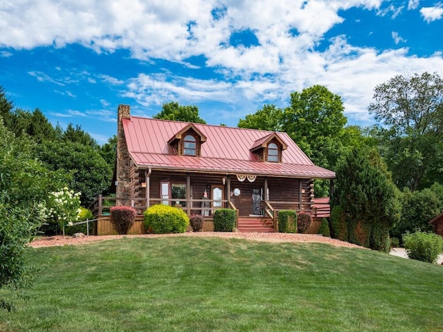 log-style house featuring a porch and a front lawn