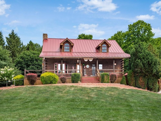 cabin featuring a porch and a front lawn