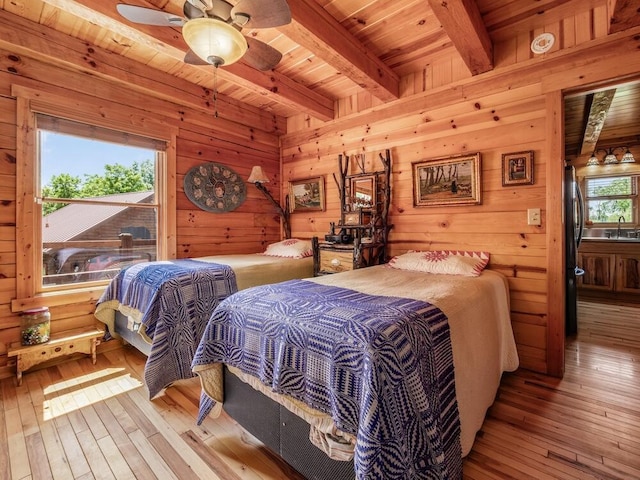 bedroom featuring multiple windows, wooden ceiling, and light hardwood / wood-style floors