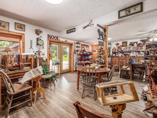 dining room with plenty of natural light, hardwood / wood-style floors, and a textured ceiling